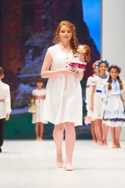MINSK-OCTOBER 29: An unidentified girl wears Lubna collection at the international exhibition of the fashion industry, Kid's fashion day during Belarus Fashion Week on October 29, 2017 in Minsk, Belar clipart