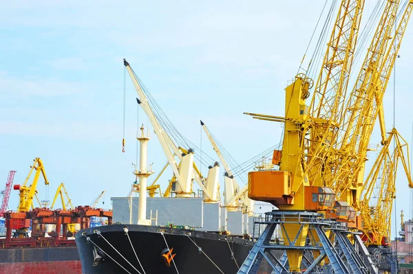 Bulk cargo ship under port crane Stock Photo