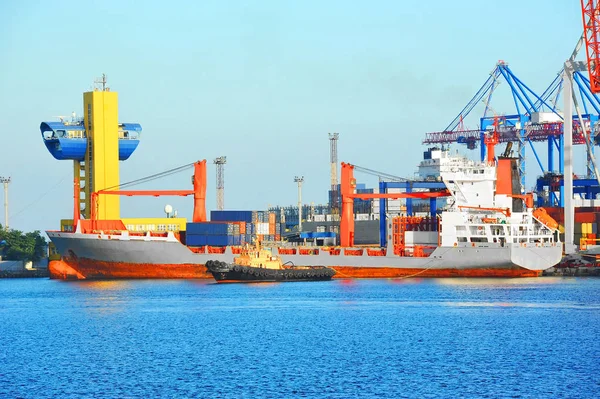 Tugboat assisting bulk cargo ship