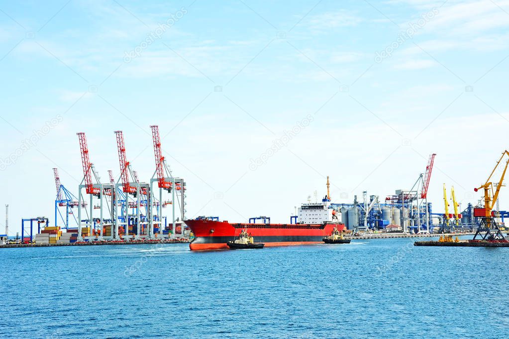 Tugboat assisting bulk cargo ship