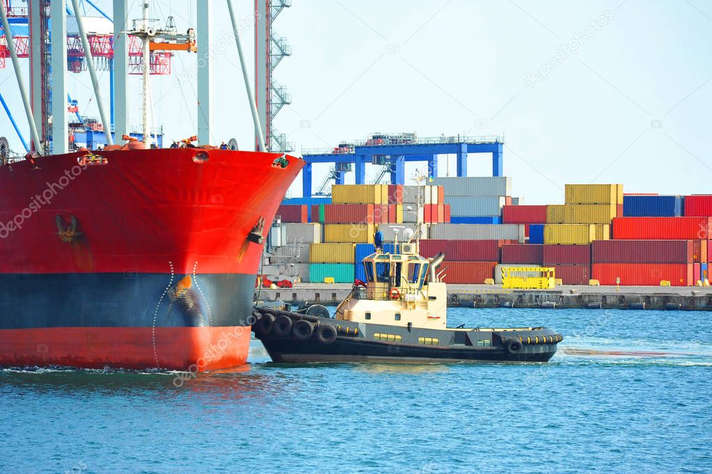 Tugboat assisting bulk cargo ship