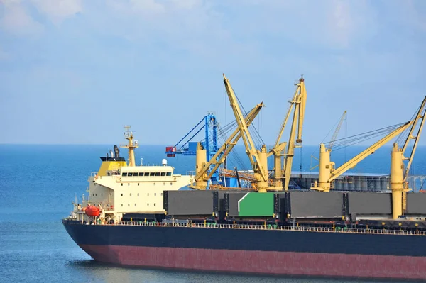 Грузовое судно под портовым краном — стоковое фото