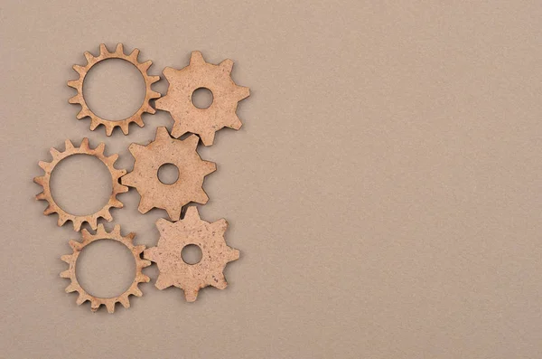 Wooden gear on cardboard — Stock Photo, Image