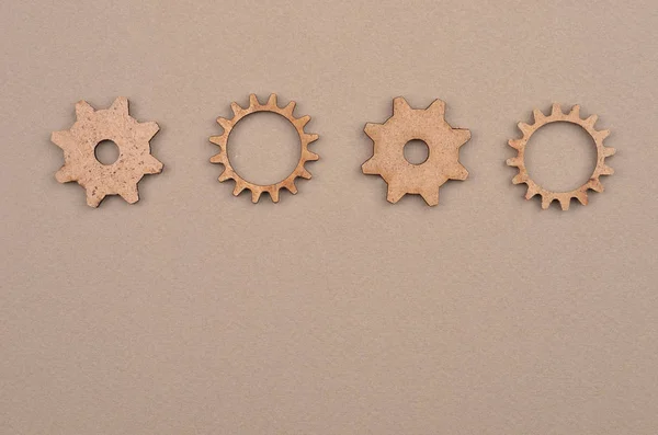 Wooden gear on cardboard — Stock Photo, Image