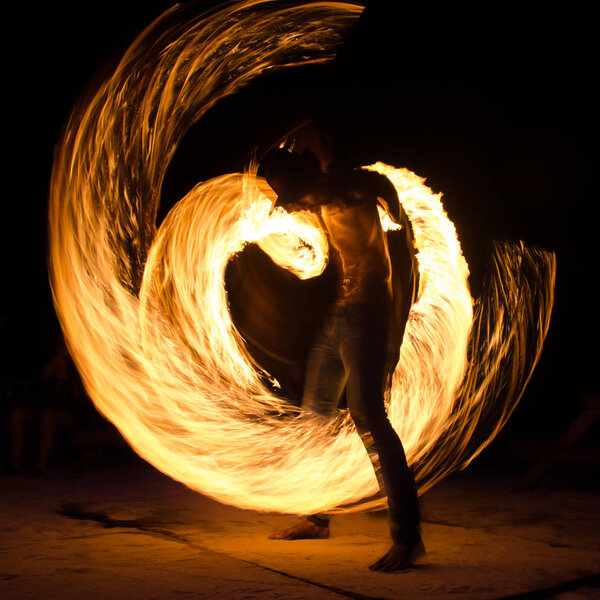 Man on beach with fire