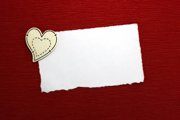 Wooden heart and white sheet of paper — Stock Photo, Image