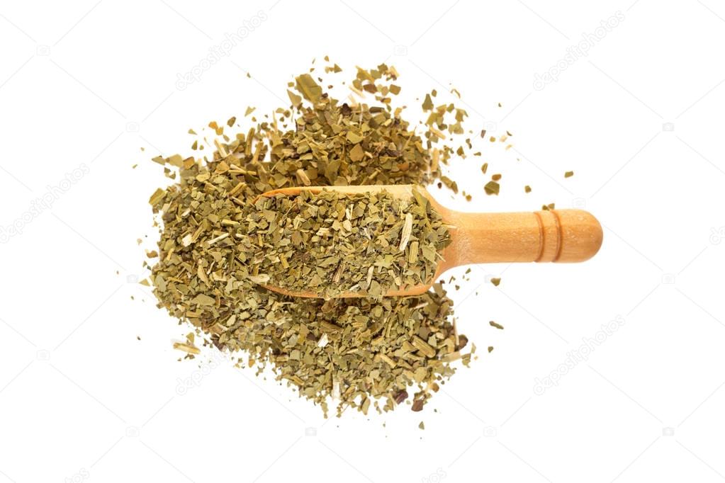 Yerba mate with a wooden spoon on isolate a white background