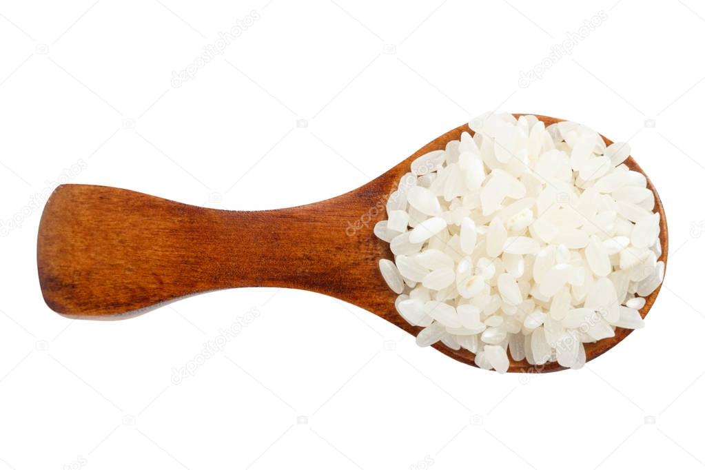 Round white rice in a brown spoon isolated on white background.. Top view