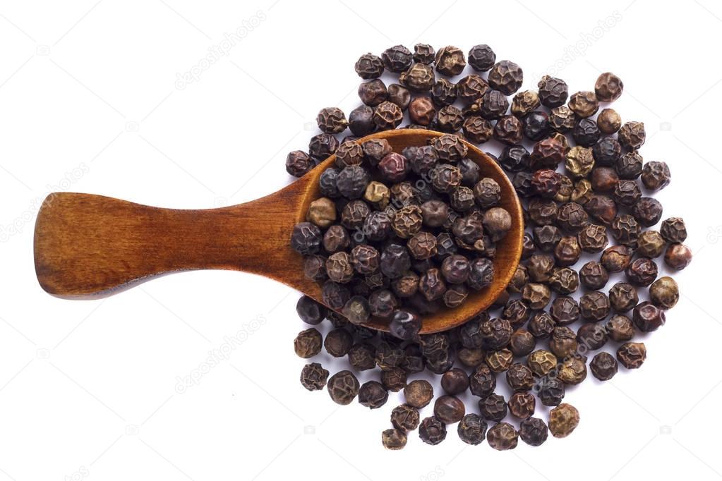 Black pepper in wooden spoon on white background.