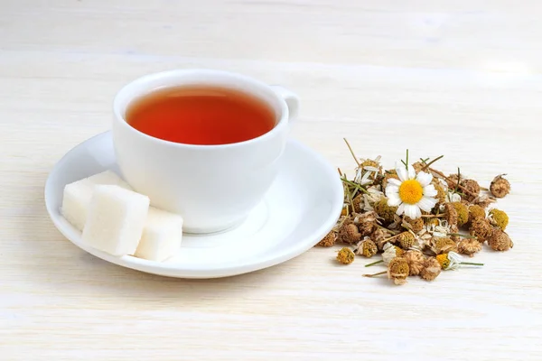 Kamillentee in einer weißen Tasse und Zuckerwürfel — Stockfoto