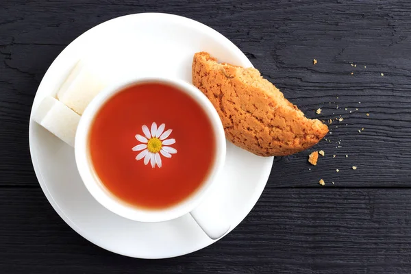 Papatya çayı şekerli yulaf ezmeli kurabiye siyah ahşap zemin ile