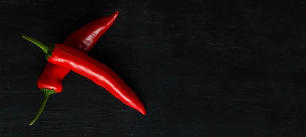 Red hot pepper on a dark background. A wide image with a place under the text — Stock Photo, Image