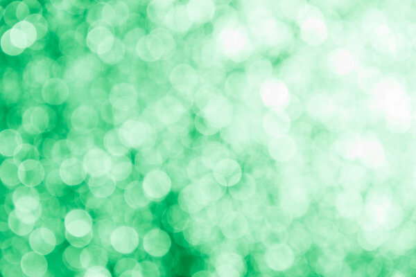 Green abstract background with blurry highlights