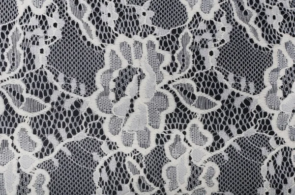 White material with lace on black background — Stock Photo, Image