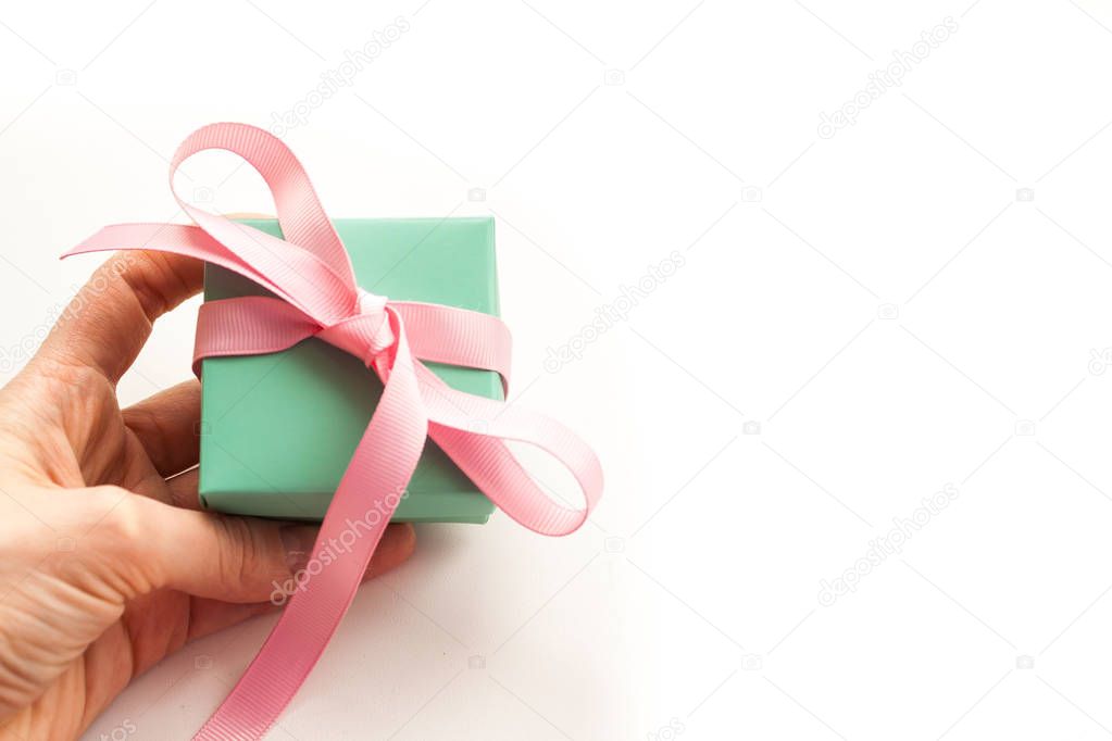 Hands holding gift box isolated on white background.