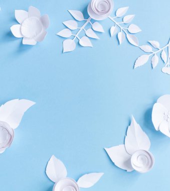 çerçeve mavi zemin üzerine beyaz kağıt çiçeklerle. Kağıttan kesilmiş.