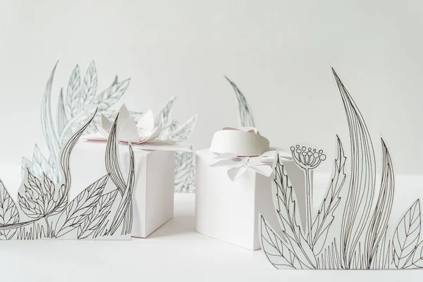 3d paper flowers with painted leaves and stems, white gifts and white paper flowers