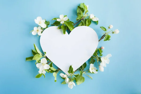 Heart frame with blossom apple on blue background — Stock Photo, Image