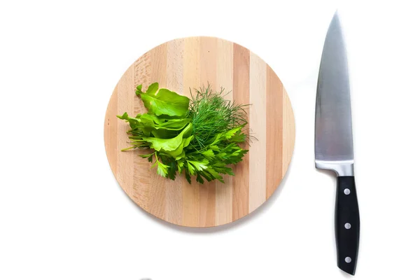 Greens lying on a chopping Board with a knife — Stock Photo, Image