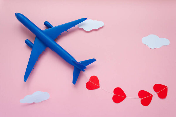 Happy Valentines day. Children's plane on a pink background with red heart