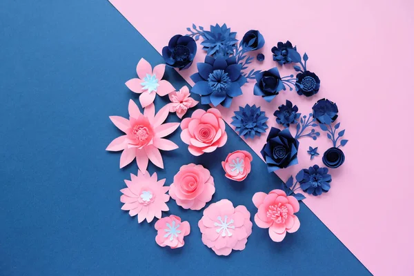 Blue paper flowers on blue background. Cut from paper.
