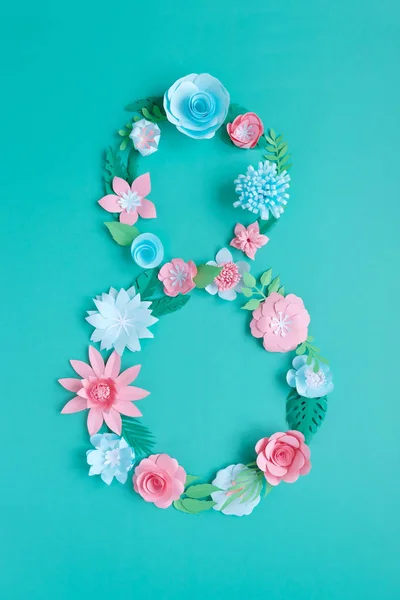 The number 8 is made of flowers cut from paper on a mint background — 스톡 사진