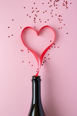 Heart of red ribbon on pink background