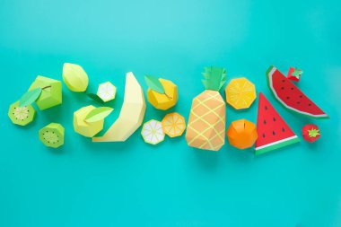 Different exotic fruits made of paper on trendy mint background