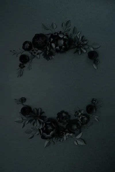 Black paper flowers on Black background. Cut from paper. Gothic frame. Total black. BLack friday concept.