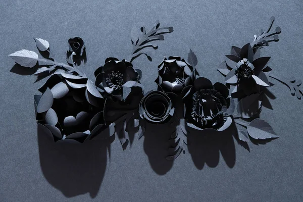 Black paper flowers on Black background. Cut from paper. Gothic frame. Total black. BLack friday concept.