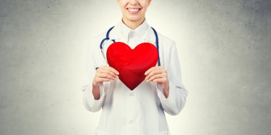 Kırmızı kalp tutan doktor