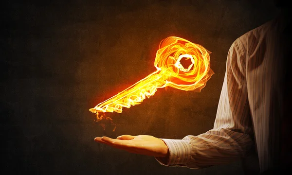 Businessman hand showing glowing key — ストック写真