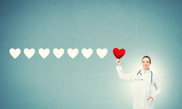 Doctor holding red heart — Stock Photo, Image