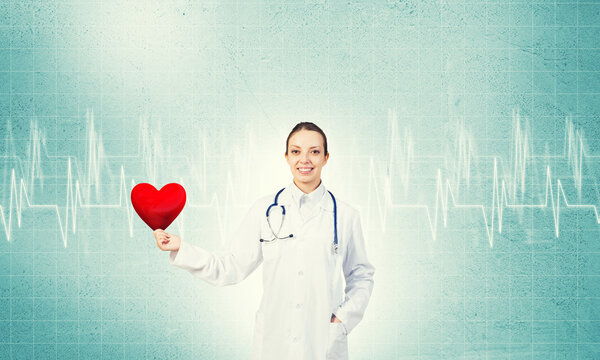 Доктор держит красное сердце
