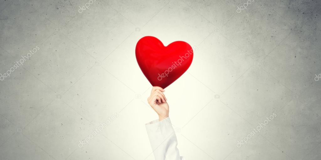 doctor holding red heart