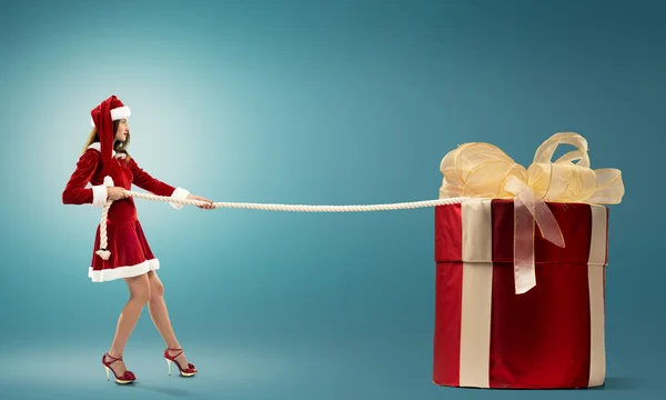 Santa woman pulling gift box — Stock Photo, Image