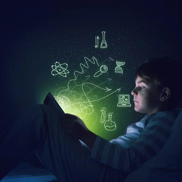 Boy with tablet in his bed — Stock Photo, Image