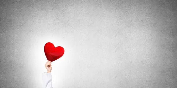 Doctor holding red heart — Stock Photo, Image