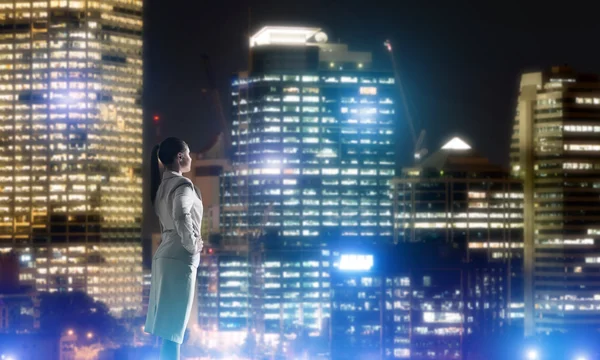 Woman looking at night city — Stock Photo, Image