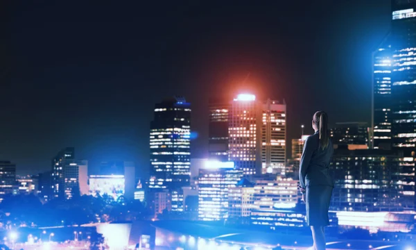 Woman looking at night city — Stock Photo, Image