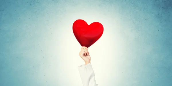 Doctor holding red heart — Stock Photo, Image