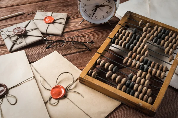 Envelopes and alarm clock on wooden table — Φωτογραφία Αρχείου