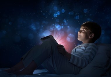 Çocuk onun yatakta tablet ile