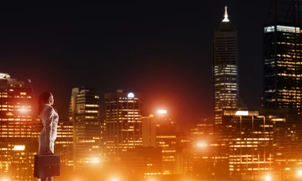 Mujer mirando la ciudad nocturna — Foto de Stock