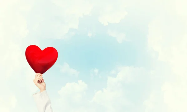 Doctor holding red heart — Stock Photo, Image