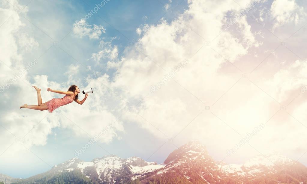 woman with megaphone flying 
