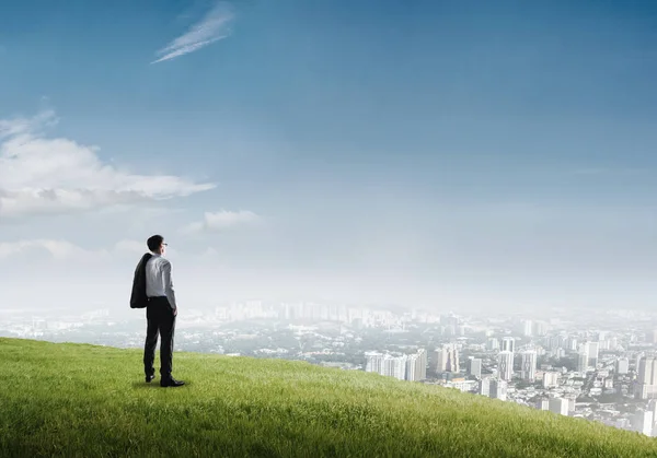 Businessman standing on top of hill — Stock Photo, Image