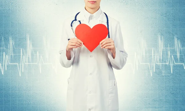 Young woman doctor  holding red heart — Stock Photo, Image