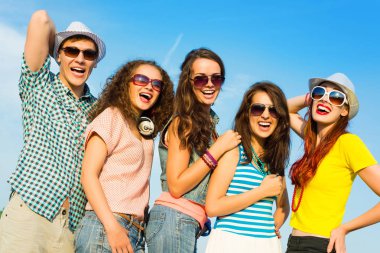group of young people wearing sunglasses and hat