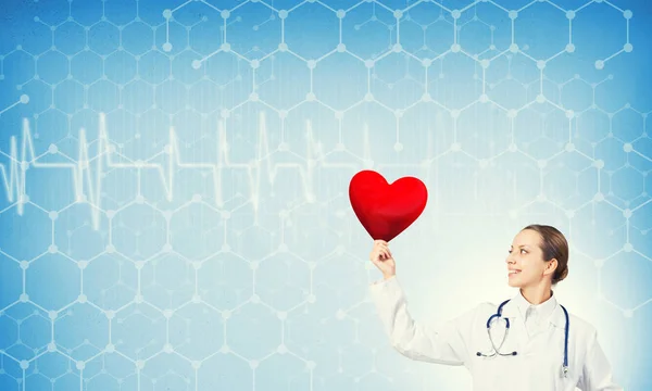 Young woman doctor  holding red heart — Stock Photo, Image